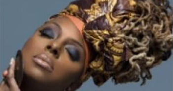 Woman with dramatic eye makeup and a colorful headwrap.
